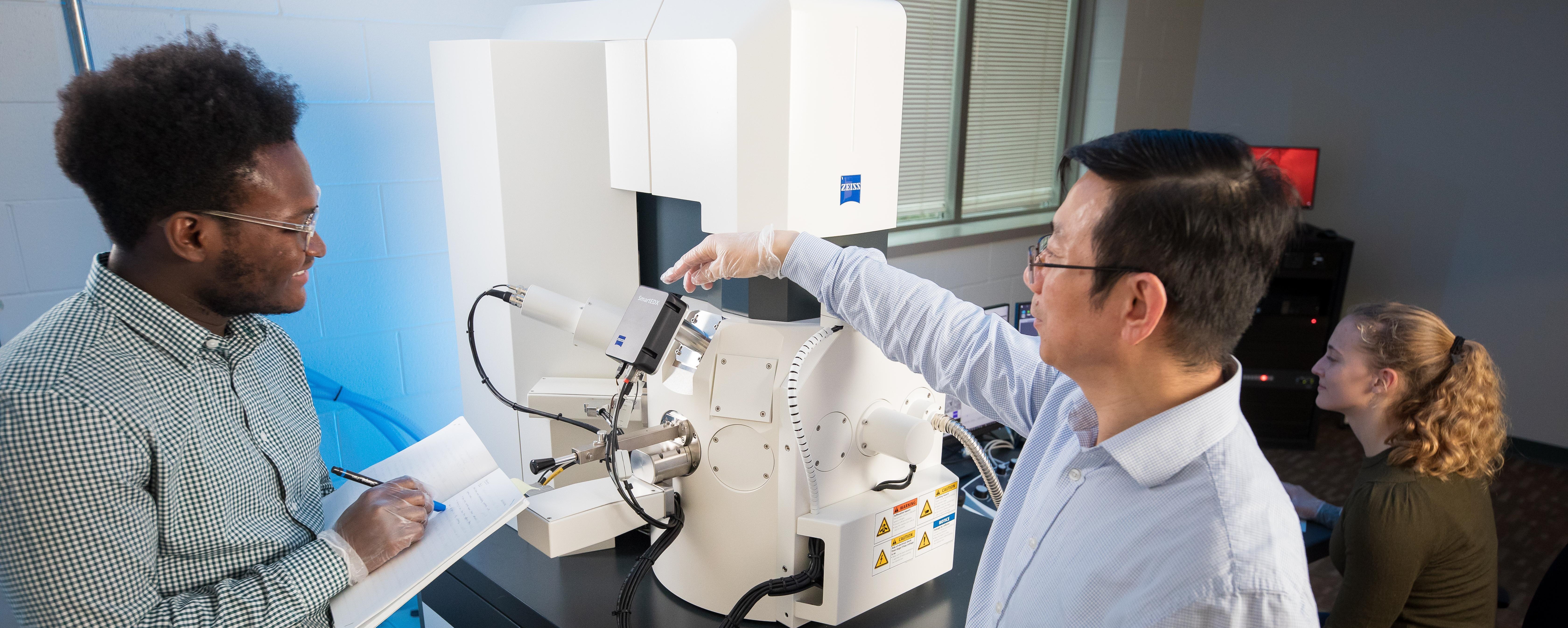 Student and Professor with Electron Microscope